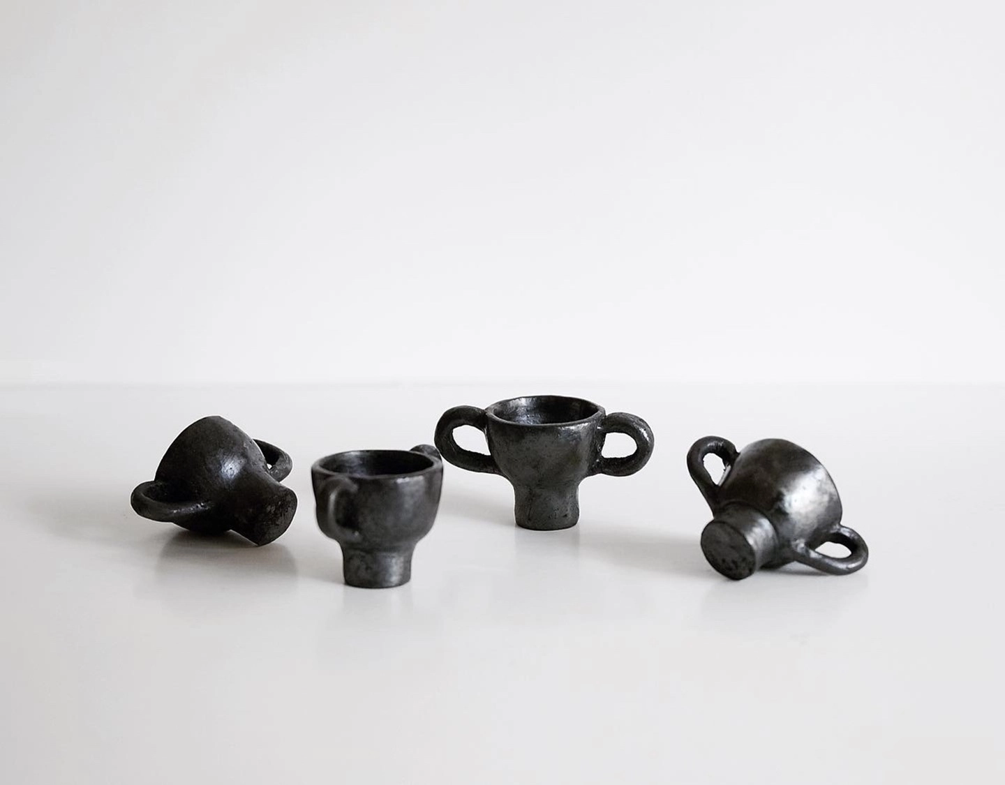 Close-up of the matte luster and hand-pinched texture on Tibetan black pottery.