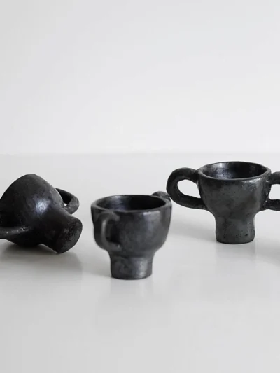 Trio of hand-pinched Tibetan black pottery dancing figurine incense holders.