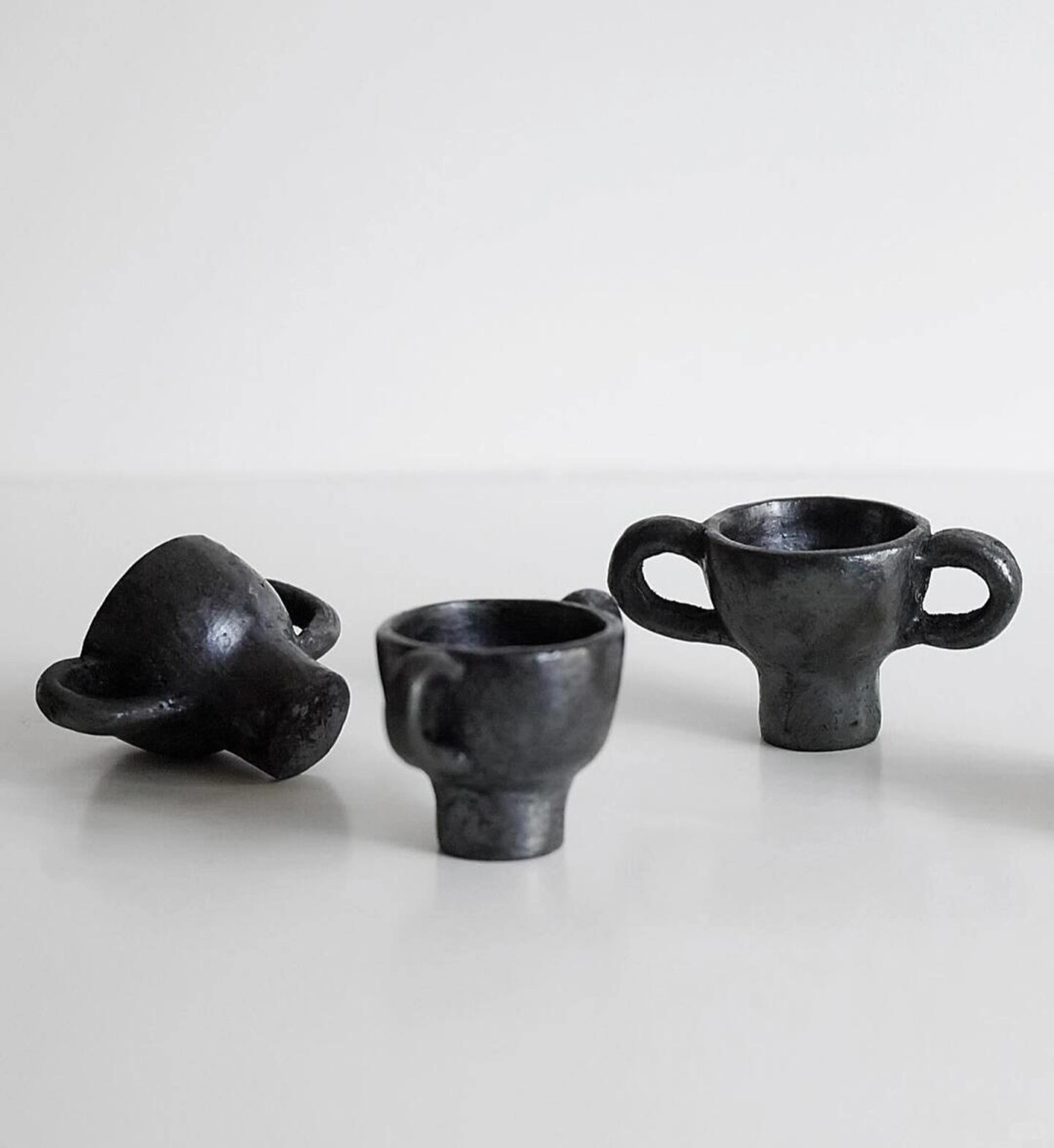 Trio of hand-pinched Tibetan black pottery dancing figurine incense holders.