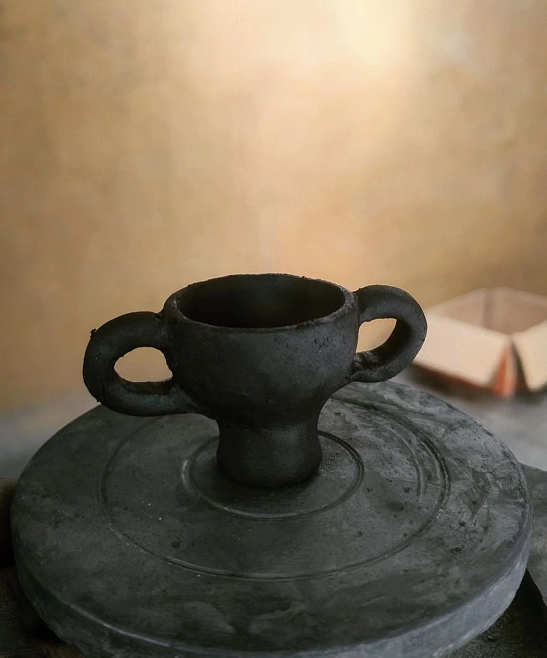 Raw hand-pinched clay stage of a Tibetan black pottery incense holder.