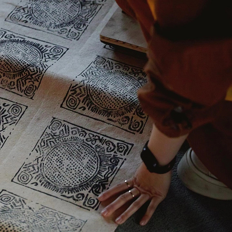 Artisans hand-printing traditional Tibetan Gyama ritual paper for SUPERTIBET Traveler incense packaging.