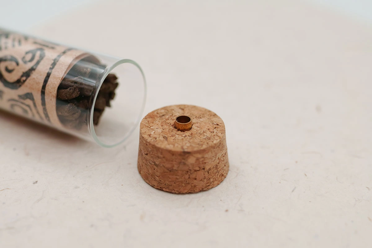 Detail shot of the natural wooden plug of SUPERTIBET Traveler incense tube for fragrance preservation.