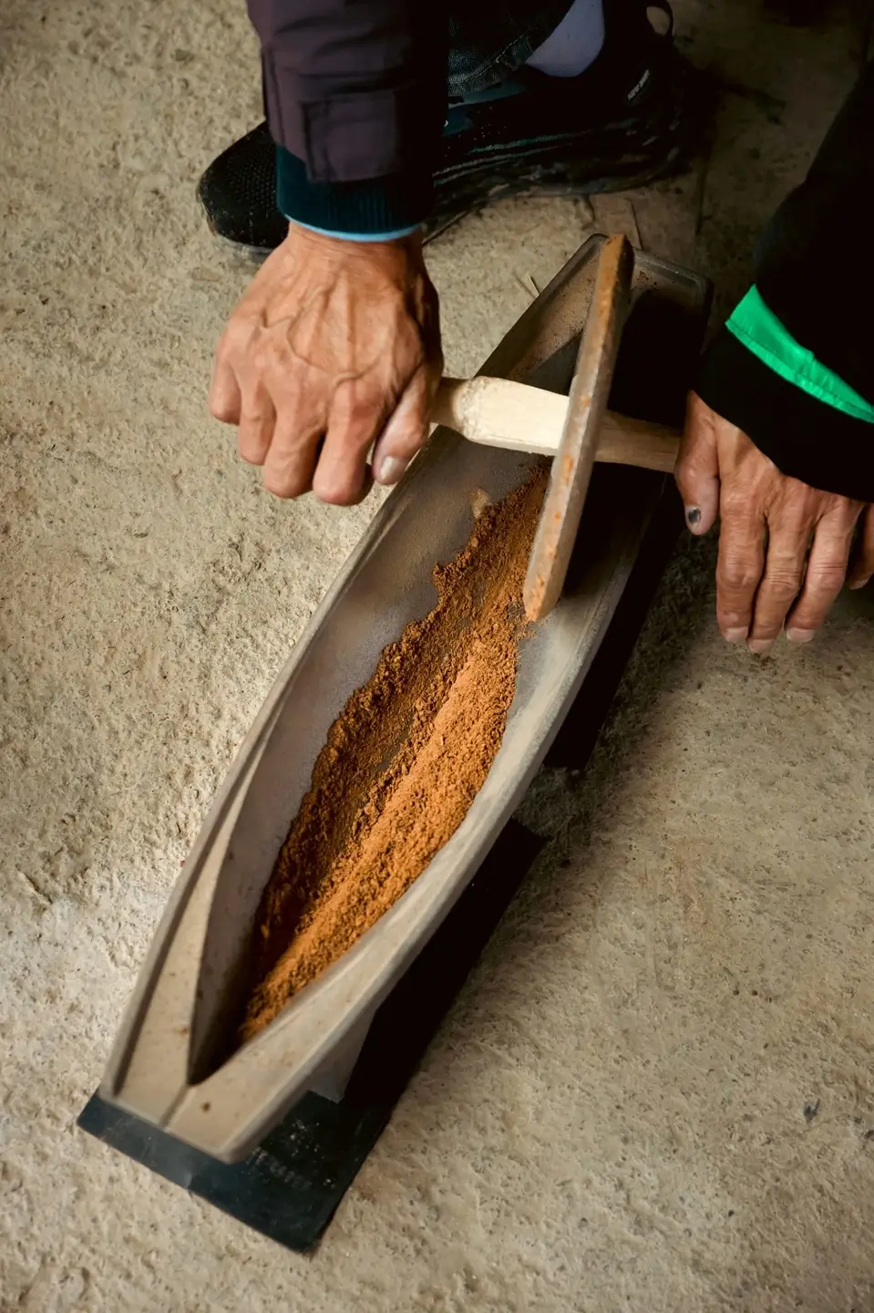 Local artisans grinding raw materials for Labrang Tibetan incense.