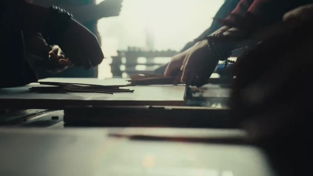 monks sort Tibetan incense sticks by hand on a worktable.